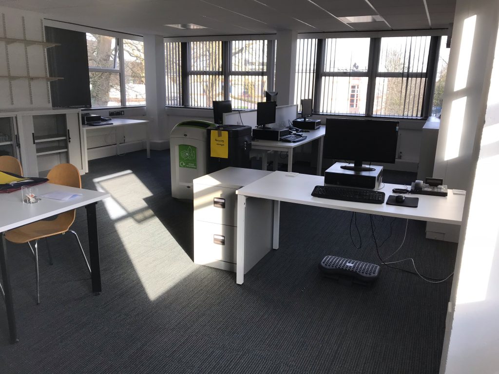 A photo of the office with furniture but otherwise empty