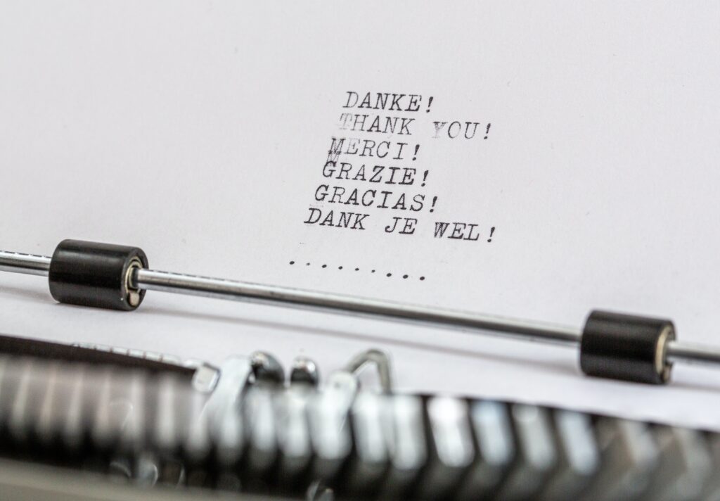 Image of a typewritten page with the words thank you in different languages.