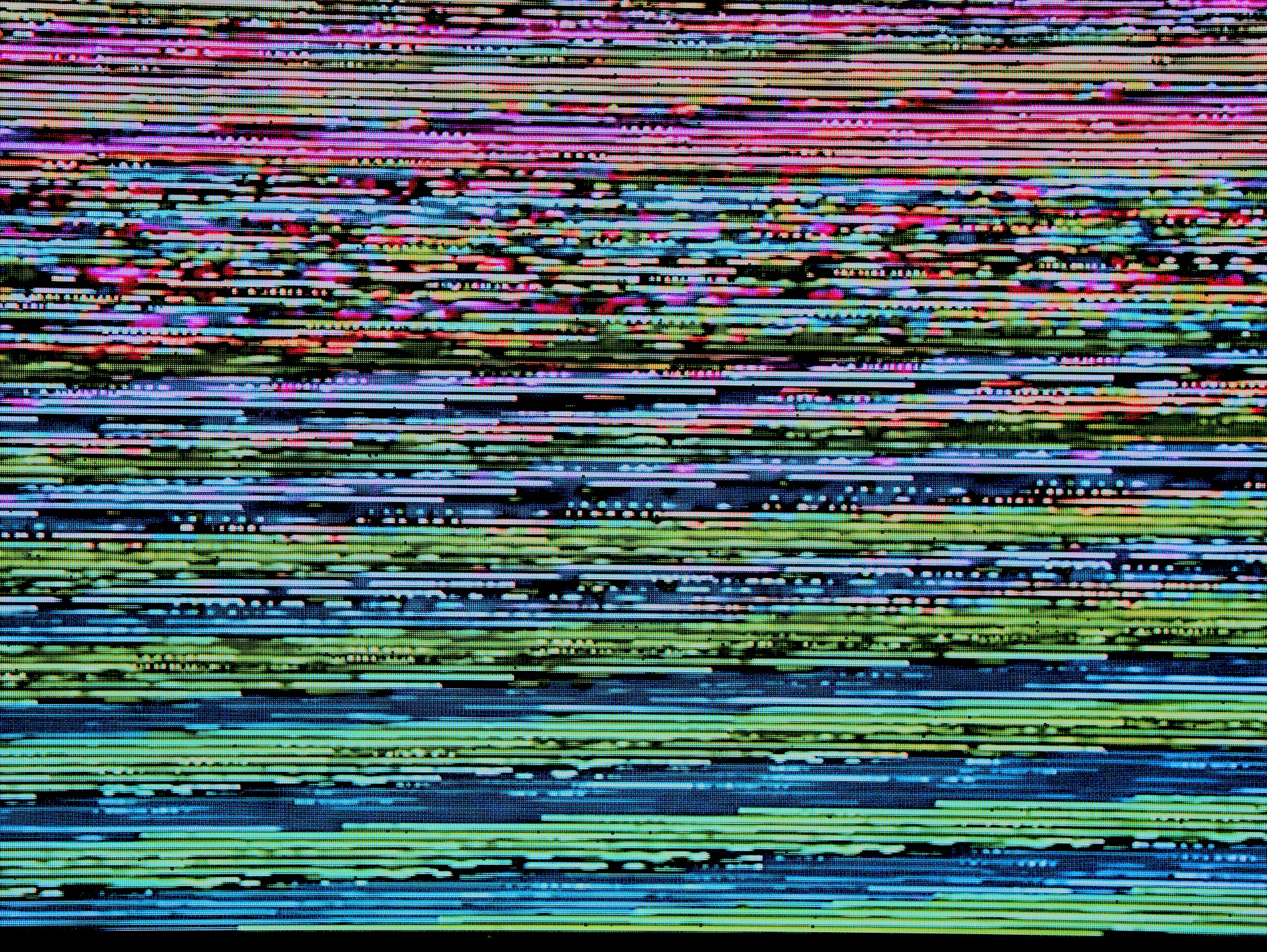 Image of glitchy screen with pixalated colours